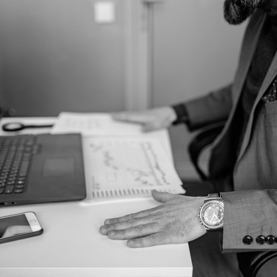 A businessman reviewing charts and graphs at his desk