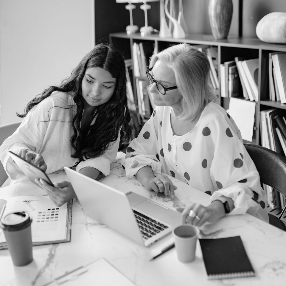 Two colleagues collaborating on a laptop